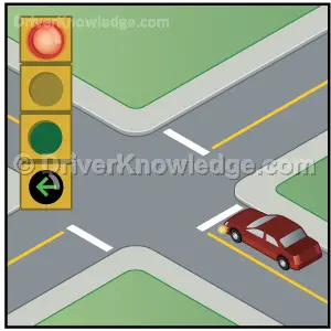 traffic light which has a green arrow and a red light